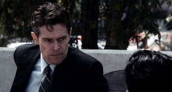 Movie still from “My Son, My Son, What Have Ye Done” (2009), directed by Werner Herzog – A man wearing a suit and tie sitting next to another man wearing a suit; Close Up shot, Over the shoulder angle