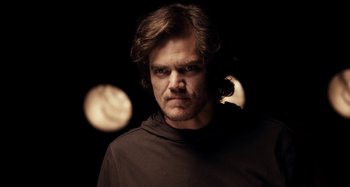 Movie still from “My Son, My Son, What Have Ye Done” (2009), directed by Werner Herzog – A person wearing a black shirt; Close Up shot, Low angle