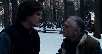 Movie still from “My Son, My Son, What Have Ye Done” (2009), directed by Werner Herzog – Two men are talking in the snow near a fence; Medium shot, Over the shoulder angle