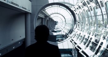 Movie still from “My Son, My Son, What Have Ye Done” (2009), directed by Werner Herzog – A person standing in front of a tunnel; Wide shot, Over the shoulder angle