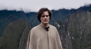 Movie still from “My Son, My Son, What Have Ye Done” (2009), directed by Werner Herzog – A man standing in front of a mountain range; Medium shot, Low angle