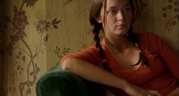 Movie still from “My Summer of Love” (2004), directed by Pawel Pawlikowski – A woman sitting on top of a green couch; Close Up shot, Over the shoulder angle