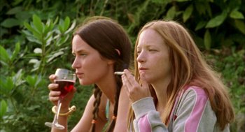 Movie still from “My Summer of Love” (2004), directed by Pawel Pawlikowski – Two women sitting next to each other with a glass of red wine; Medium shot, Low angle