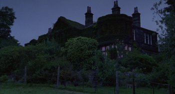 Movie still from “My Summer of Love” (2004), directed by Pawel Pawlikowski – A house that is covered in vegetation at night time; Extreme Wide shot, Low angle