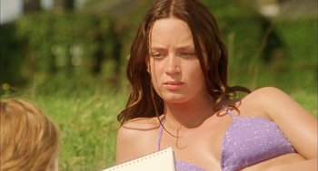 Movie still from “My Summer of Love” (2004), directed by Pawel Pawlikowski – A woman sitting in the grass holding a notebook; Close Up shot, Low angle