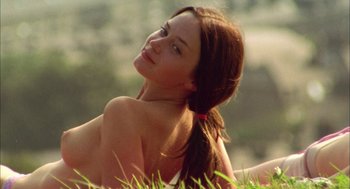 Movie still from “My Summer of Love” (2004), directed by Pawel Pawlikowski – A beautiful young lady sitting in a field; Medium shot, Low angle