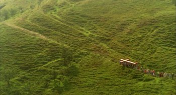 Movie still from “My Summer of Love” (2004), directed by Pawel Pawlikowski – An aerial view of an open field with trees; Extreme Wide shot, High angle