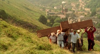 Movie still from “My Summer of Love” (2004), directed by Pawel Pawlikowski – A group of people standing on top of a green hill; Extreme Wide shot, High angle