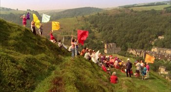 Movie still from “My Summer of Love” (2004), directed by Pawel Pawlikowski – A group of people sitting on top of a green hill; Extreme Wide shot, High angle