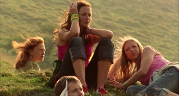Movie still from “My Summer of Love” (2004), directed by Pawel Pawlikowski – A group of people sitting on top of a grass covered hill; Medium shot, Low angle