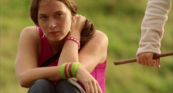 Movie still from “My Summer of Love” (2004), directed by Pawel Pawlikowski – A woman sitting on the ground with her hands on her knees; Close Up shot, Low angle
