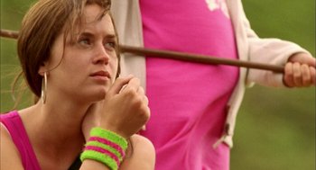 Movie still from “My Summer of Love” (2004), directed by Pawel Pawlikowski – A person wearing a pink shirt; Close Up shot, Over the shoulder angle