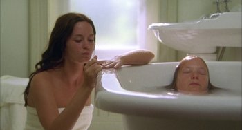 Movie still from “My Summer of Love” (2004), directed by Pawel Pawlikowski – A woman in a bathroom brushing her teeth; Medium shot, High angle