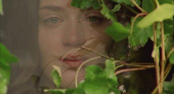 Movie still from “My Summer of Love” (2004), directed by Pawel Pawlikowski – A woman's face through leaves; Extreme Close Up shot, High angle