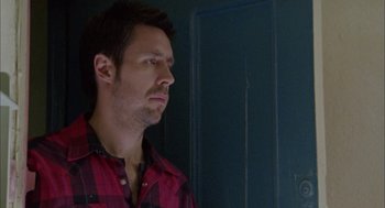 Movie still from “My Summer of Love” (2004), directed by Pawel Pawlikowski – A person wearing a red and black shirt; Close Up shot, Low angle