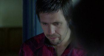 Movie still from “My Summer of Love” (2004), directed by Pawel Pawlikowski – A person wearing a red and black shirt; Close Up shot, Over the shoulder angle