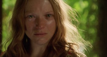 Movie still from “My Summer of Love” (2004), directed by Pawel Pawlikowski – A woman's face in front of trees; Close Up shot, Low angle
