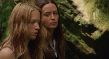 Movie still from “My Summer of Love” (2004), directed by Pawel Pawlikowski – Two young women sitting next to each other in front of a tree; Close Up shot, Low angle