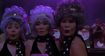 Movie still from “Mystery Men” (1999), directed by Kinka Usher – A couple of older women standing next to each other; Close Up shot, Low angle