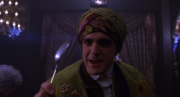Movie still from “Mystery Men” (1999), directed by Kinka Usher – A man in a turban holding a spoon in his hand; Close Up shot, Low angle