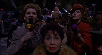 Movie still from “Mystery Men” (1999), directed by Kinka Usher – A group of people with microphones in a crowd; Close Up shot, Low angle