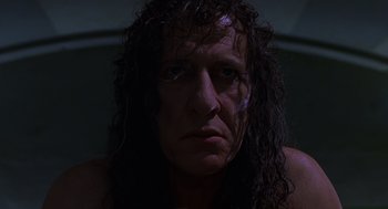 Movie still from “Mystery Men” (1999), directed by Kinka Usher – A person with long black hair; Close Up shot, Low angle