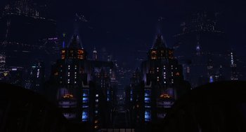 Movie still from “Mystery Men” (1999), directed by Kinka Usher – A view of a city at night from the ground; Extreme Wide shot, High angle