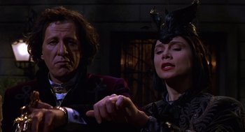 Movie still from “Mystery Men” (1999), directed by Kinka Usher – A man and a woman are looking at a clock; Medium shot, Low angle