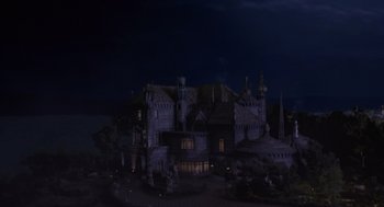 Movie still from “Mystery Men” (1999), directed by Kinka Usher – A dark picture of an old castle with a dark sky; Extreme Wide shot, High angle