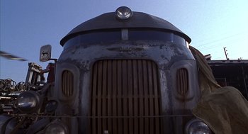 Movie still from “Mystery Men” (1999), directed by Kinka Usher – The front of an old train car; Wide shot, Low angle