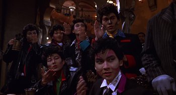 Movie still from “Mystery Men” (1999), directed by Kinka Usher – A group of young men in suits and ties; Medium shot, Low angle