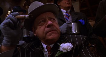 Movie still from “Mystery Men” (1999), directed by Kinka Usher – An older man wearing a suit and a hat; Close Up shot, Low angle