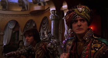 Movie still from “Mystery Men” (1999), directed by Kinka Usher – A group of people standing next to each other in a room; Medium shot, Low angle