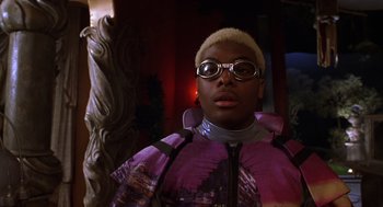 Movie still from “Mystery Men” (1999), directed by Kinka Usher – A person wearing a purple jacket and a pair of goggles; Close Up shot, Low angle