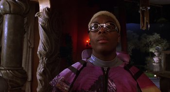 Movie still from “Mystery Men” (1999), directed by Kinka Usher – A man wearing a purple jacket and a pair of goggles; Close Up shot, Low angle