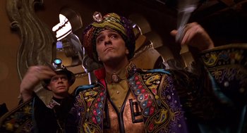 Movie still from “Mystery Men” (1999), directed by Kinka Usher – A man wearing a colorful costume and a colorful hat; Medium shot, Low angle