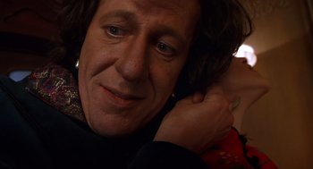 Movie still from “Mystery Men” (1999), directed by Kinka Usher – A person holding a hand on the shoulder of another person; Close Up shot, Low angle