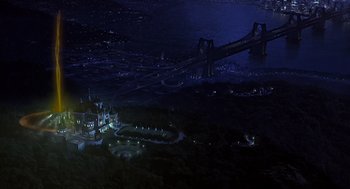 Movie still from “Mystery Men” (1999), directed by Kinka Usher – An aerial view of a city at night with a bridge; Extreme Wide shot, High angle