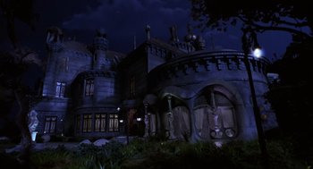 Movie still from “Mystery Men” (1999), directed by Kinka Usher – A large building that has a lot of lights on it; Extreme Wide shot, Low angle