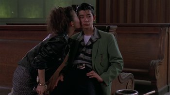 Movie still from “Mystery Train” (1989), directed by Jim Jarmusch – A man and a woman are kissing in front of a window; Medium shot, Over the shoulder angle