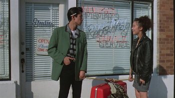 Movie still from “Mystery Train” (1989), directed by Jim Jarmusch – A man and a woman standing next to each other; Wide shot, Low angle