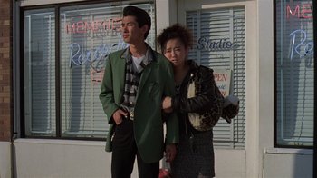 Movie still from “Mystery Train” (1989), directed by Jim Jarmusch – A man and a woman standing next to each other on the street; Medium shot, Low angle
