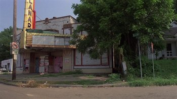 Movie still from “Mystery Train” (1989), directed by Jim Jarmusch – An abandoned building with a tree in front of it; Extreme Wide shot, Low angle