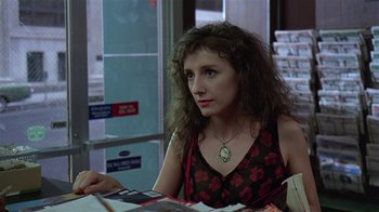 Movie still from “Mystery Train” (1989), directed by Jim Jarmusch – A woman sitting at a table looking at a piece of paper; Close Up shot, Over the shoulder angle