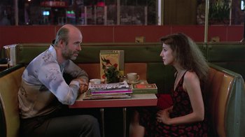 Movie still from “Mystery Train” (1989), directed by Jim Jarmusch – A man and a woman sitting at a table; Medium shot, Over the shoulder angle