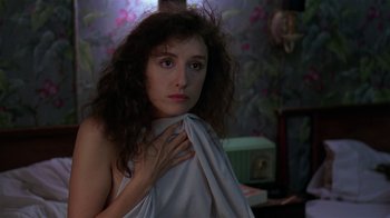 Movie still from “Mystery Train” (1989), directed by Jim Jarmusch – A woman with a white towel around her neck; Close Up shot, Over the shoulder angle