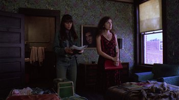 Movie still from “Mystery Train” (1989), directed by Jim Jarmusch – Two women standing in a living room holding papers; Wide shot, Low angle