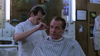 Movie still from “Mystery Train” (1989), directed by Jim Jarmusch – A man getting his hair cut by a barber; Close Up shot, Low angle