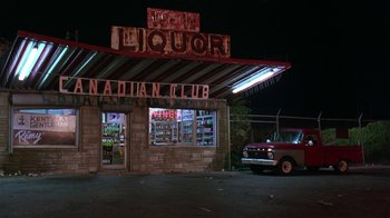 Movie still from “Mystery Train” (1989), directed by Jim Jarmusch – An old truck parked in front of a liquor store at night; Extreme Wide shot, Low angle