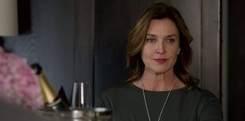 Movie still from “13 Reasons Why” (2017), created by Brian Yorkey – A person wearing a necklace near a wine glass; Close Up shot, Over the shoulder angle